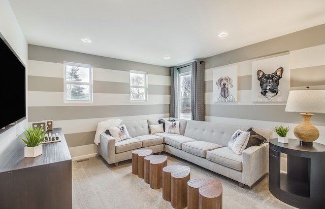 living room featuring visible vents, recessed lighting, light colored carpet, and baseboards