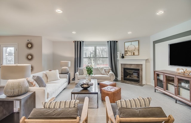 living room featuring light colored carpet and a tile fireplace