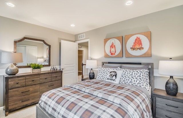 bedroom with light colored carpet, recessed lighting, and visible vents