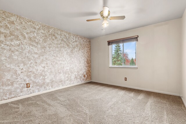 empty room with carpet floors and ceiling fan