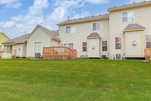 rear view of house with a wooden deck, central AC, and a lawn