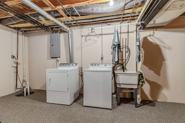 laundry area with carpet floors, sink, electric panel, and washer and clothes dryer