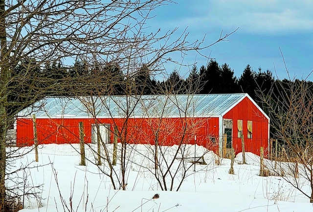 yard covered in snow with a pole building and an outdoor structure