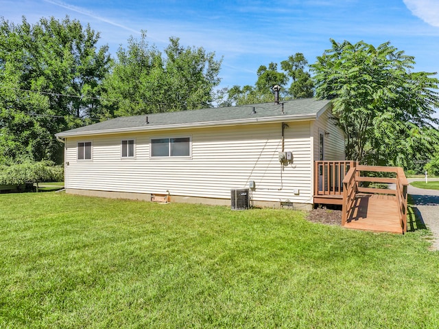 view of property exterior with central AC, a yard, and a deck