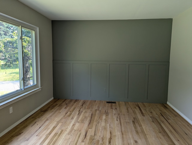 unfurnished room with light hardwood / wood-style floors