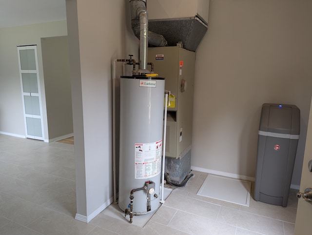 utility room featuring heating unit and gas water heater