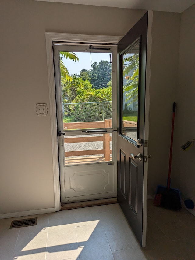 doorway with light tile patterned flooring