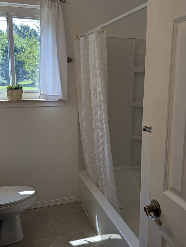 bathroom with tile patterned flooring, toilet, and shower / bath combo with shower curtain