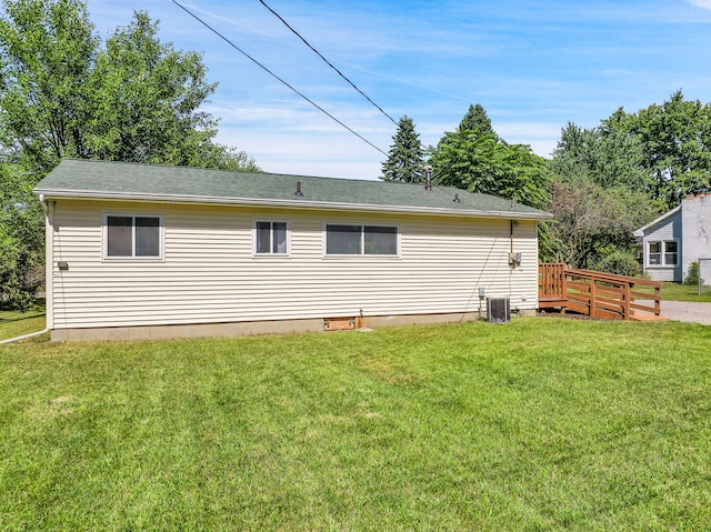 exterior space featuring central AC, a yard, and a deck