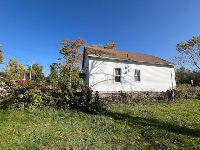 view of side of home featuring a yard