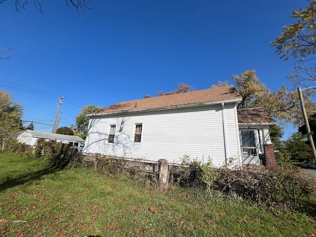 view of side of home featuring a lawn