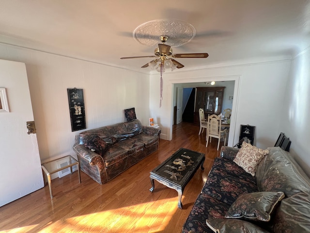 living room featuring hardwood / wood-style floors and ceiling fan