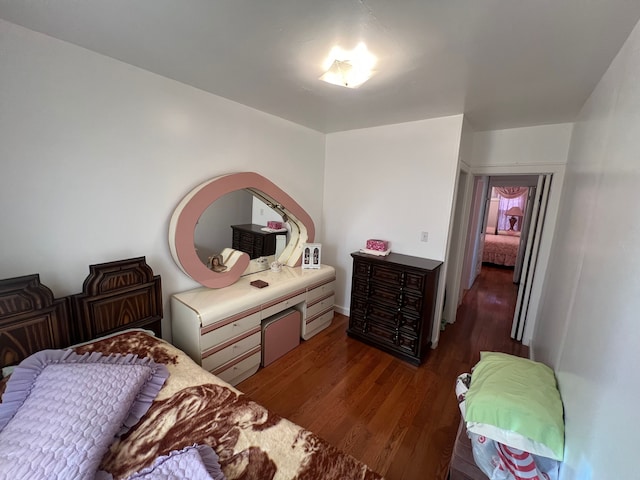 bedroom with dark hardwood / wood-style floors