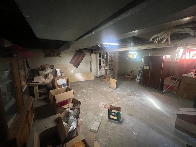 basement with fridge with ice dispenser