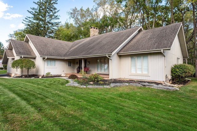 ranch-style house with a front yard and covered porch