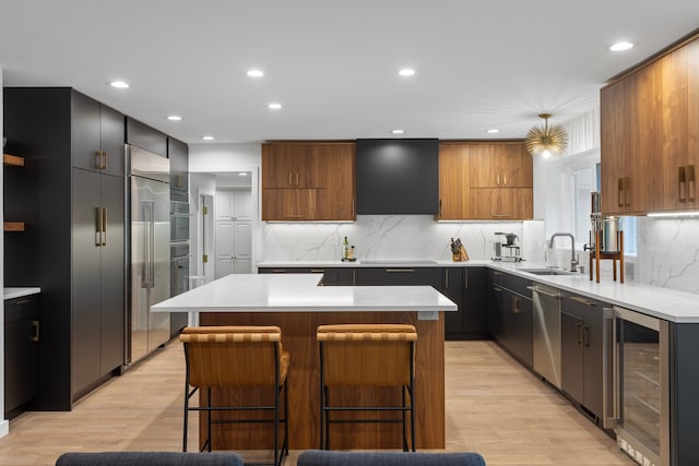 kitchen featuring a center island, a breakfast bar area, beverage cooler, and decorative backsplash