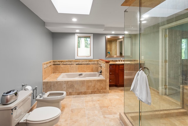 full bathroom with a bidet, a skylight, vanity, independent shower and bath, and toilet