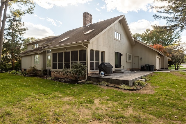 back of house with a patio area and a lawn