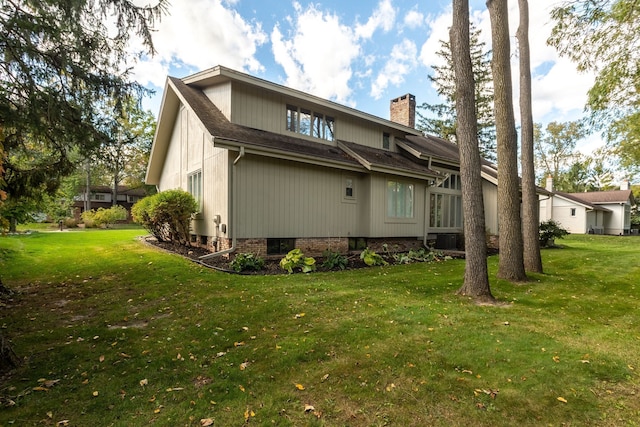 rear view of house featuring a lawn