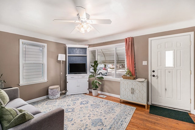 living room featuring hardwood / wood-style flooring and ceiling fan