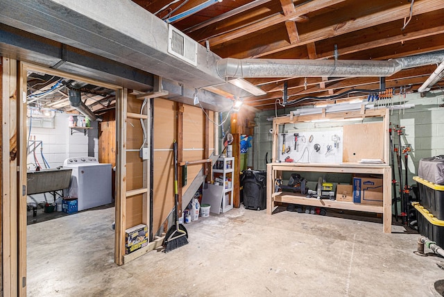 basement featuring washer / dryer and sink