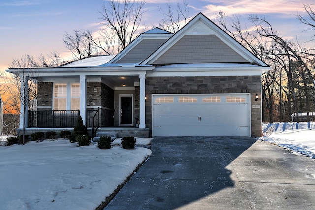 view of front of property featuring a porch and a garage