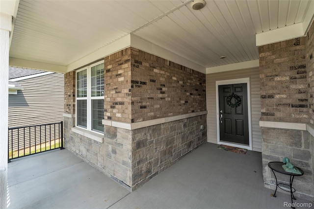 4633 Crestway Dr, Brighton, MI 48116 - property entrance with a porch and stone siding