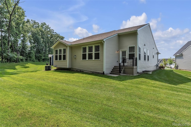 4633 Crestway Dr, Brighton, MI 48116 - rear view of house with a lawn and roof with shingles