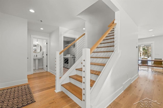 stairway with hardwood / wood-style flooring