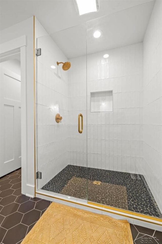 bathroom with tile patterned flooring and a shower with shower door