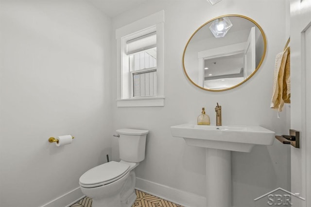 bathroom with tile patterned floors and toilet