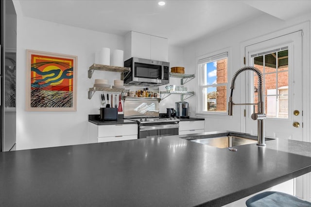 kitchen with white cabinetry, appliances with stainless steel finishes, and sink