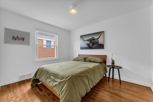 bedroom with hardwood / wood-style flooring