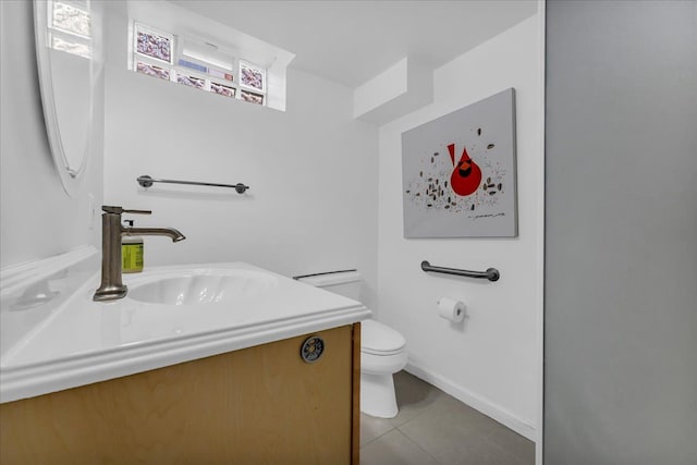 bathroom featuring vanity, tile patterned floors, and toilet