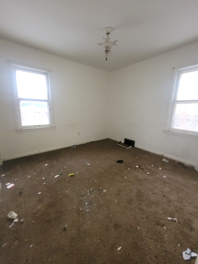 unfurnished room featuring plenty of natural light