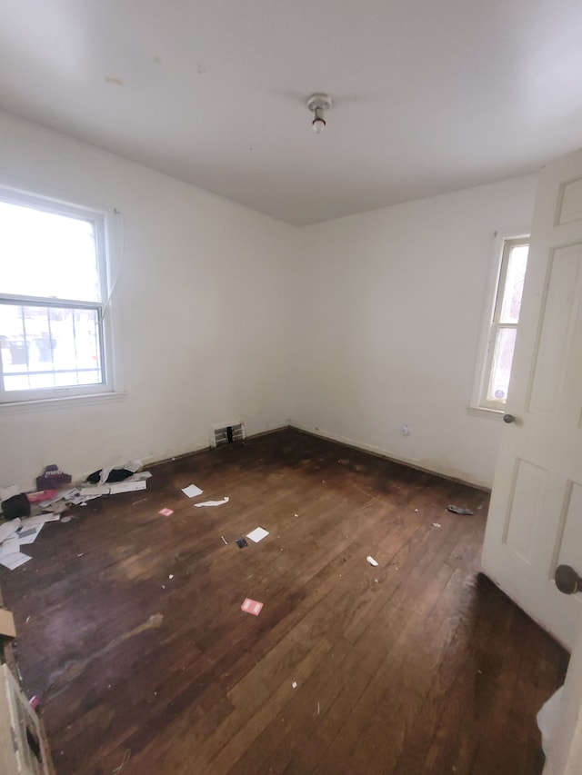 empty room featuring dark hardwood / wood-style flooring