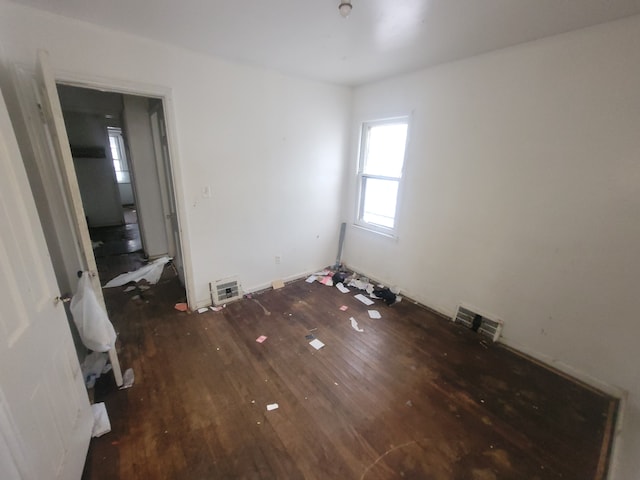 unfurnished bedroom featuring dark hardwood / wood-style flooring