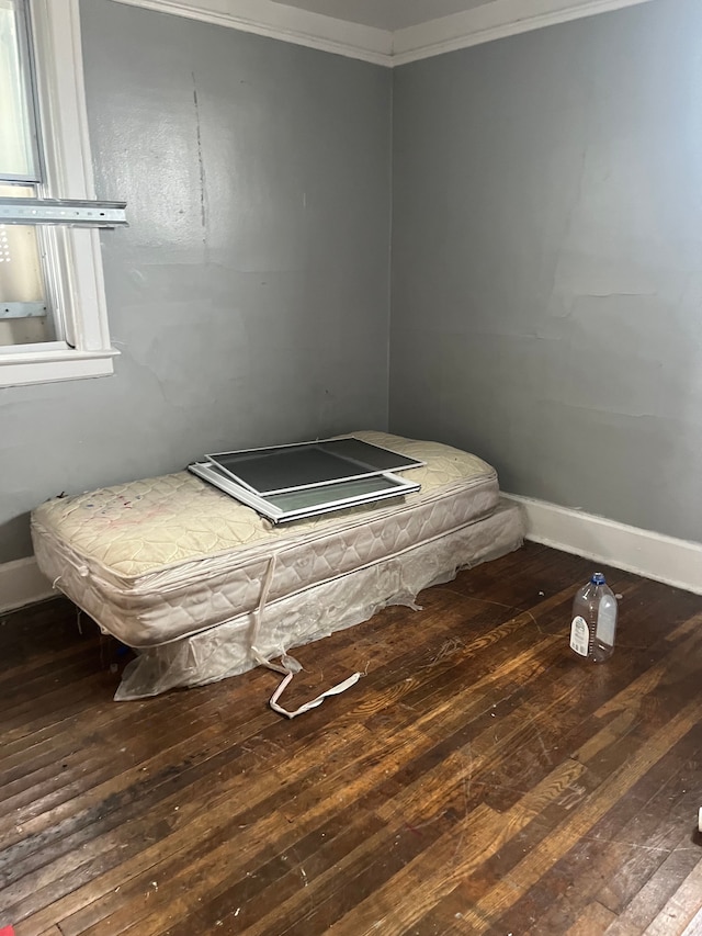 bedroom featuring ornamental molding and hardwood / wood-style floors