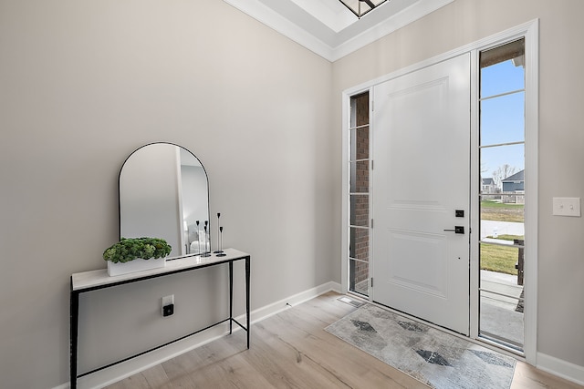 entryway with crown molding and light hardwood / wood-style floors