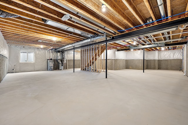 basement featuring heating unit and water heater