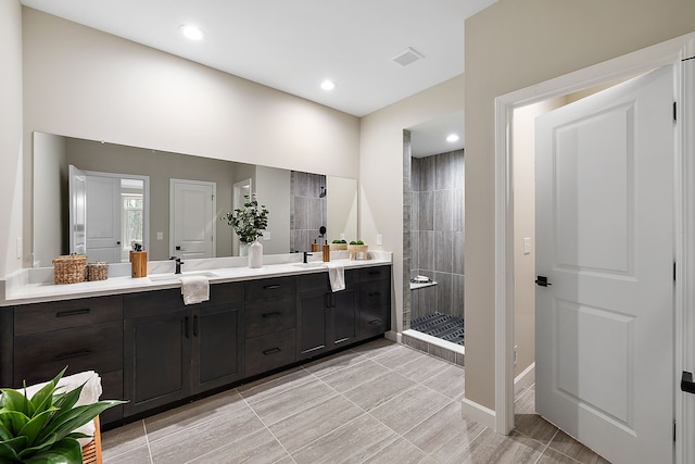 bathroom featuring vanity and a tile shower