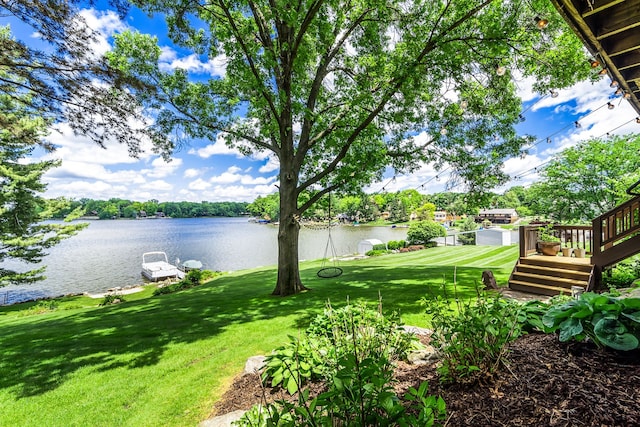 view of yard featuring a water view and a boat dock