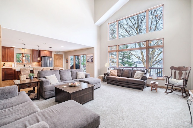 living room featuring light carpet and a high ceiling