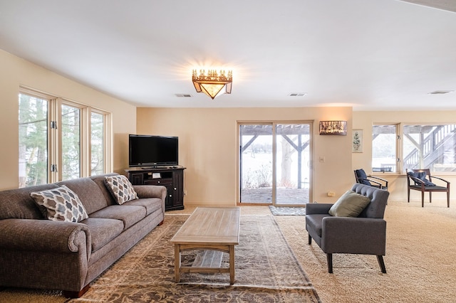 carpeted living room with a healthy amount of sunlight