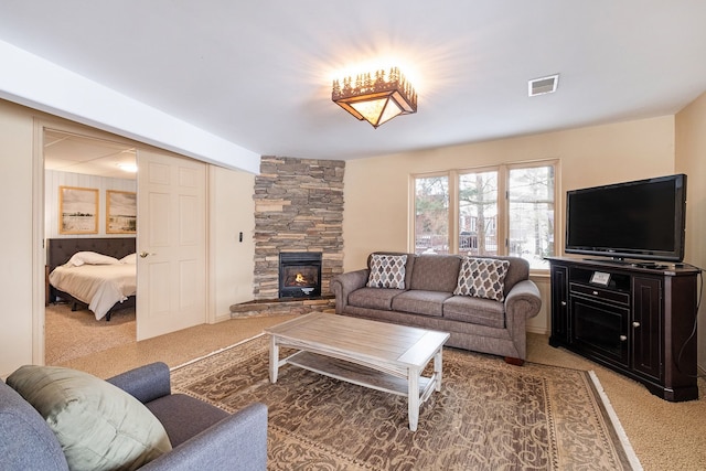 living room with a fireplace and carpet