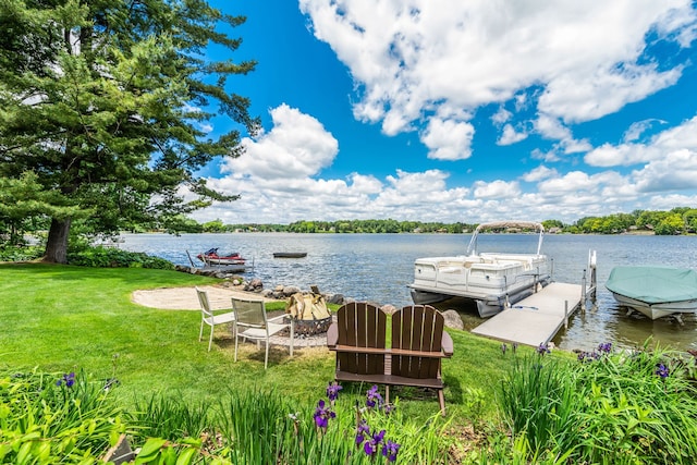 view of dock featuring a water view and a lawn