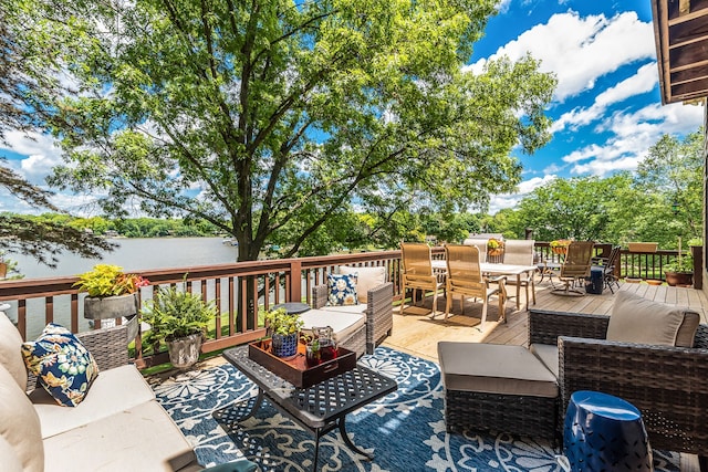 wooden terrace featuring an outdoor living space and a water view