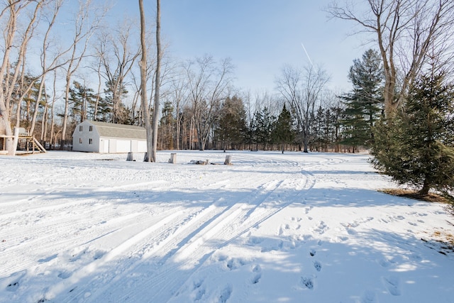 yard layered in snow featuring an outbuilding