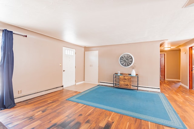 interior space featuring hardwood / wood-style floors and baseboard heating