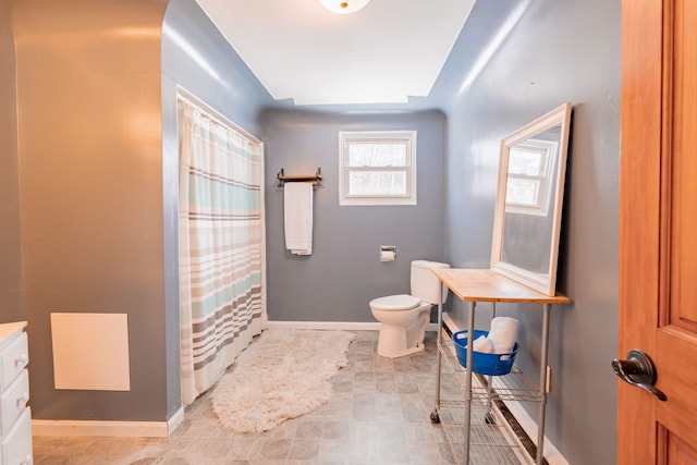 bathroom with vanity, toilet, and a shower with shower curtain